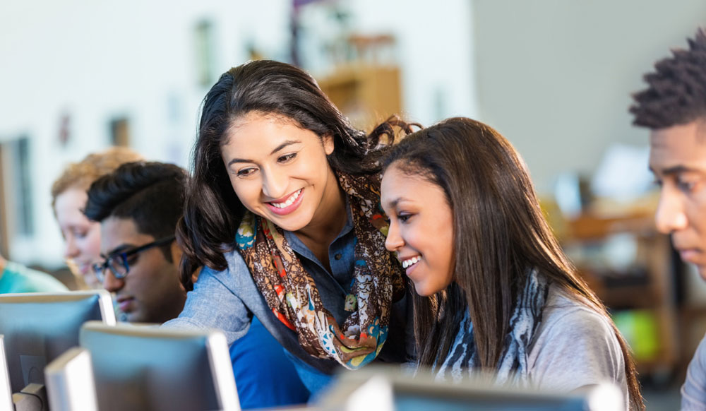 teacher-helping-student-on-computer2